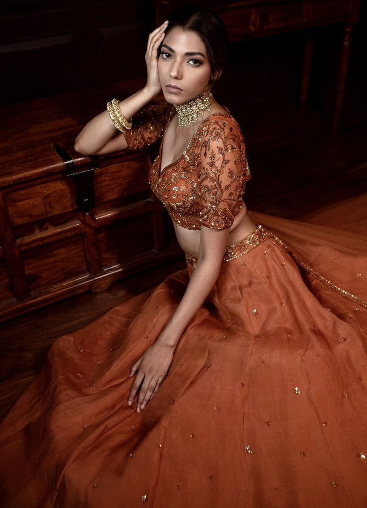 Photo of burnt orange sabyasachi lehenga with floral dupatta