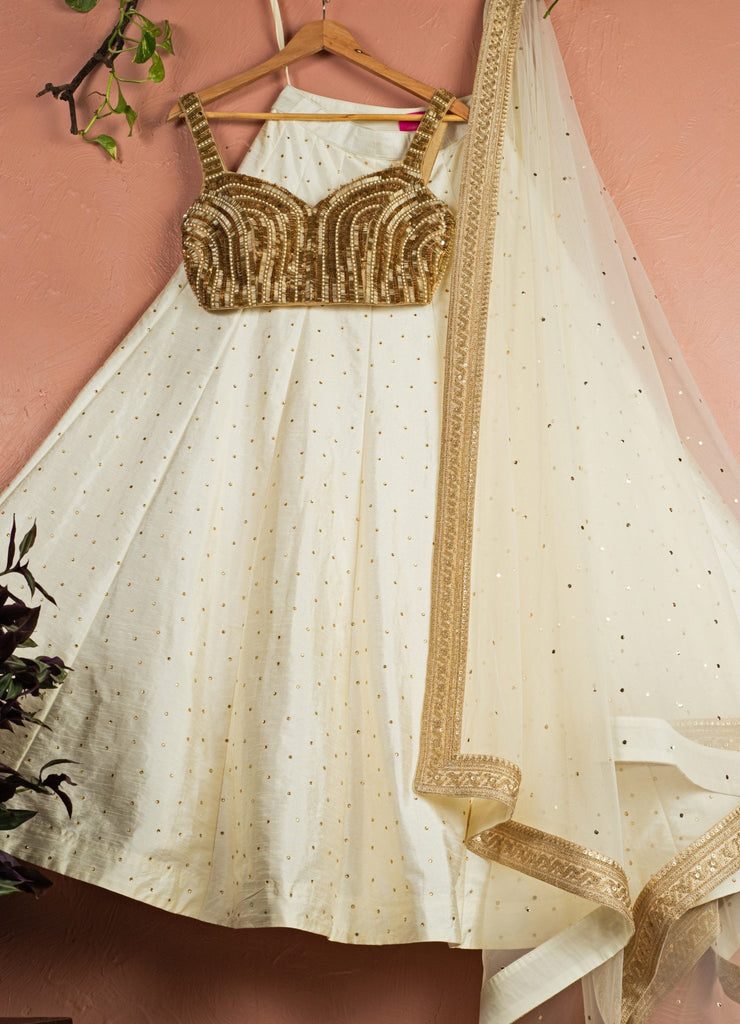 Ivory Silk Lehenga Set With Gold Sequin Sleeveless Blouse